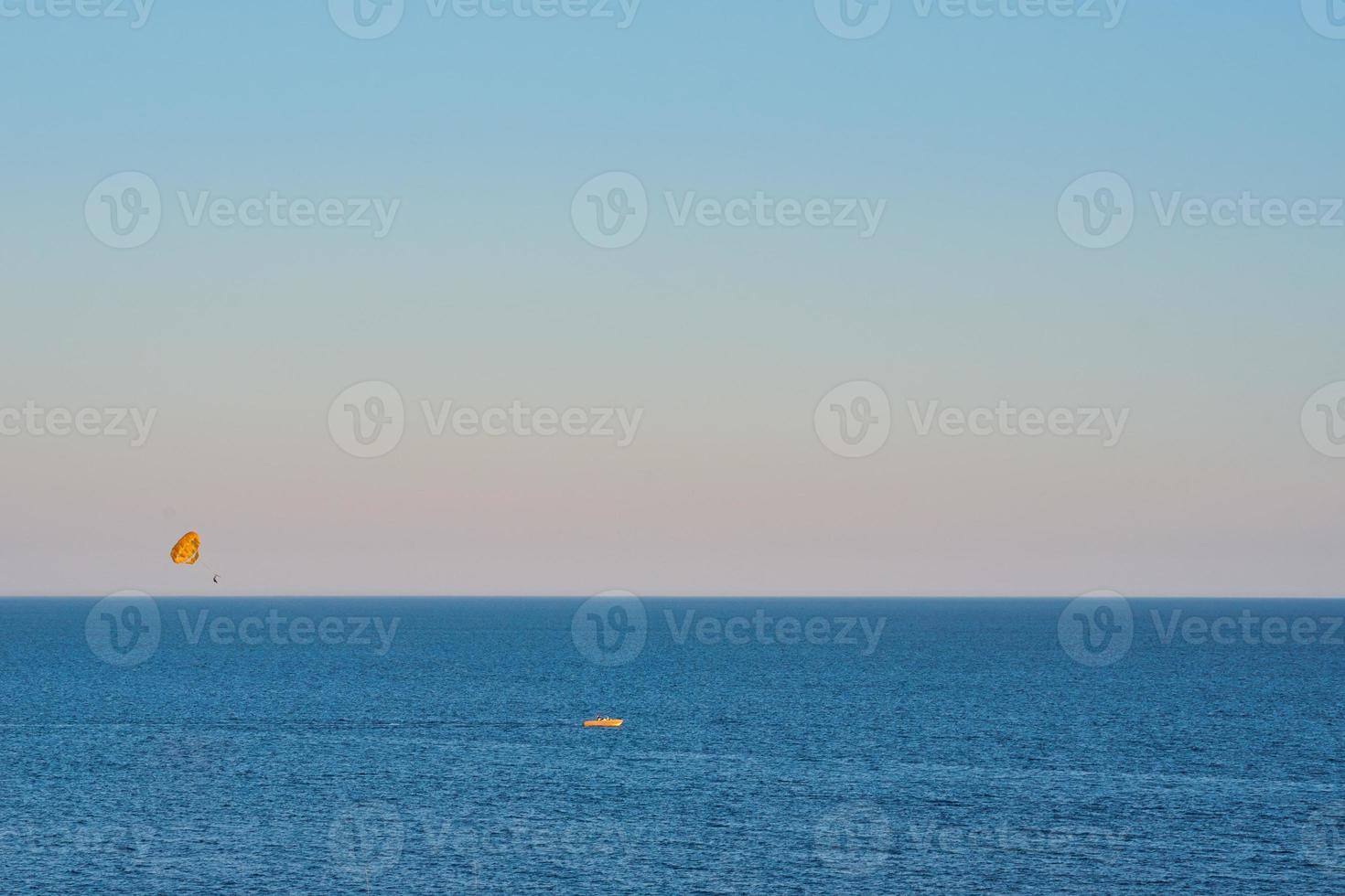 touristes de divertissement en méditerranée. parachute au-dessus de la mer photo