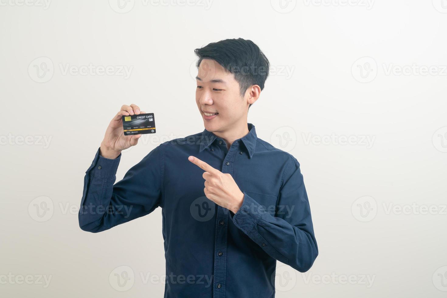 jeune homme asiatique tenant une carte de crédit photo