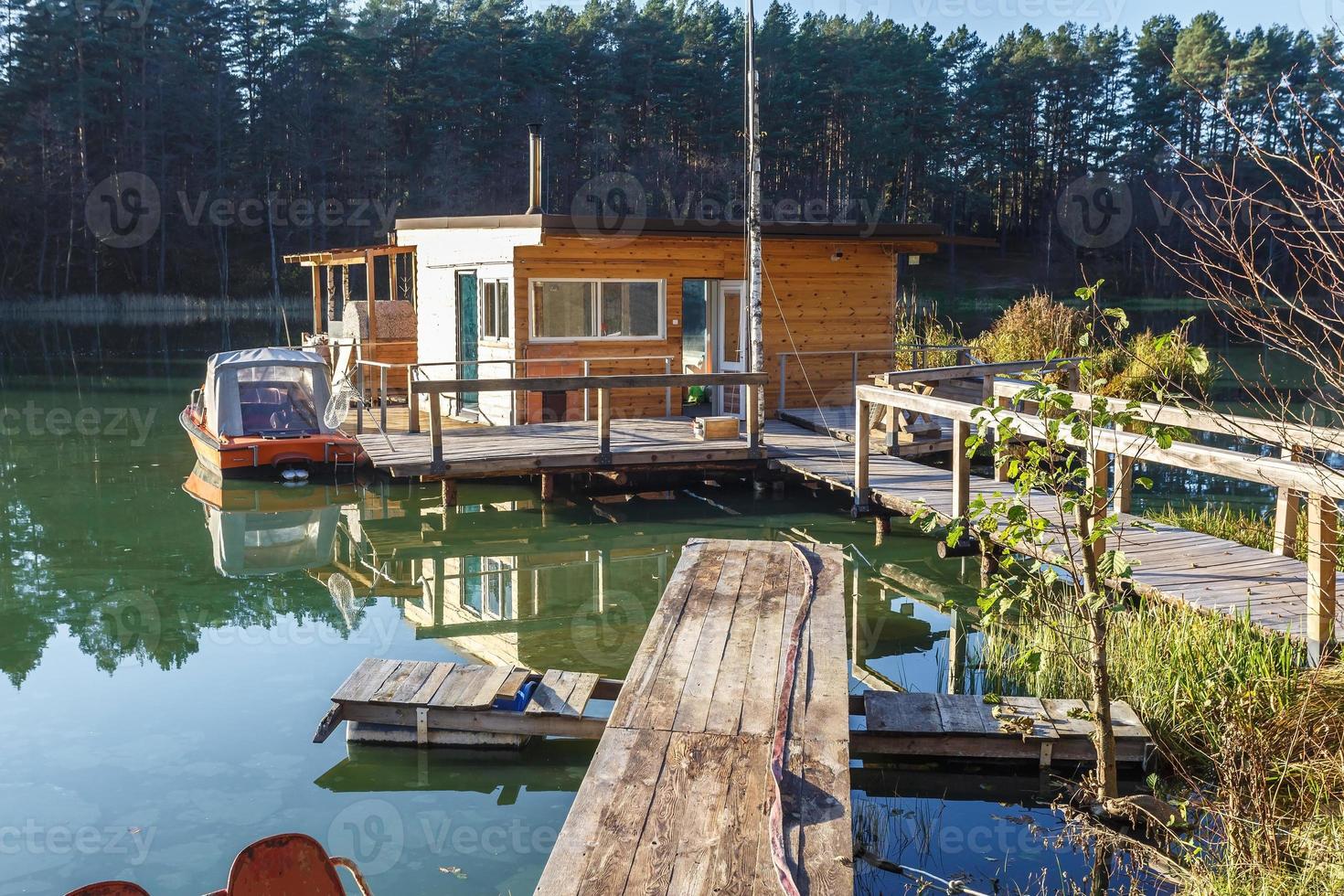 maison de débarcadère sur une jetée en bois dans l'eau en forêt en soirée photo