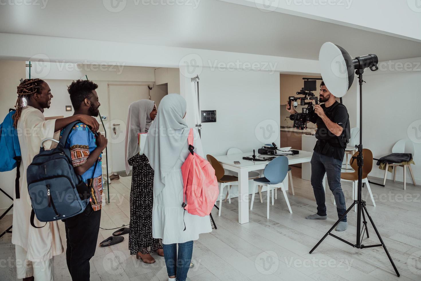 un vidéaste dans un home studio capture un groupe d'étudiants modernes avec une caméra professionnelle. photo