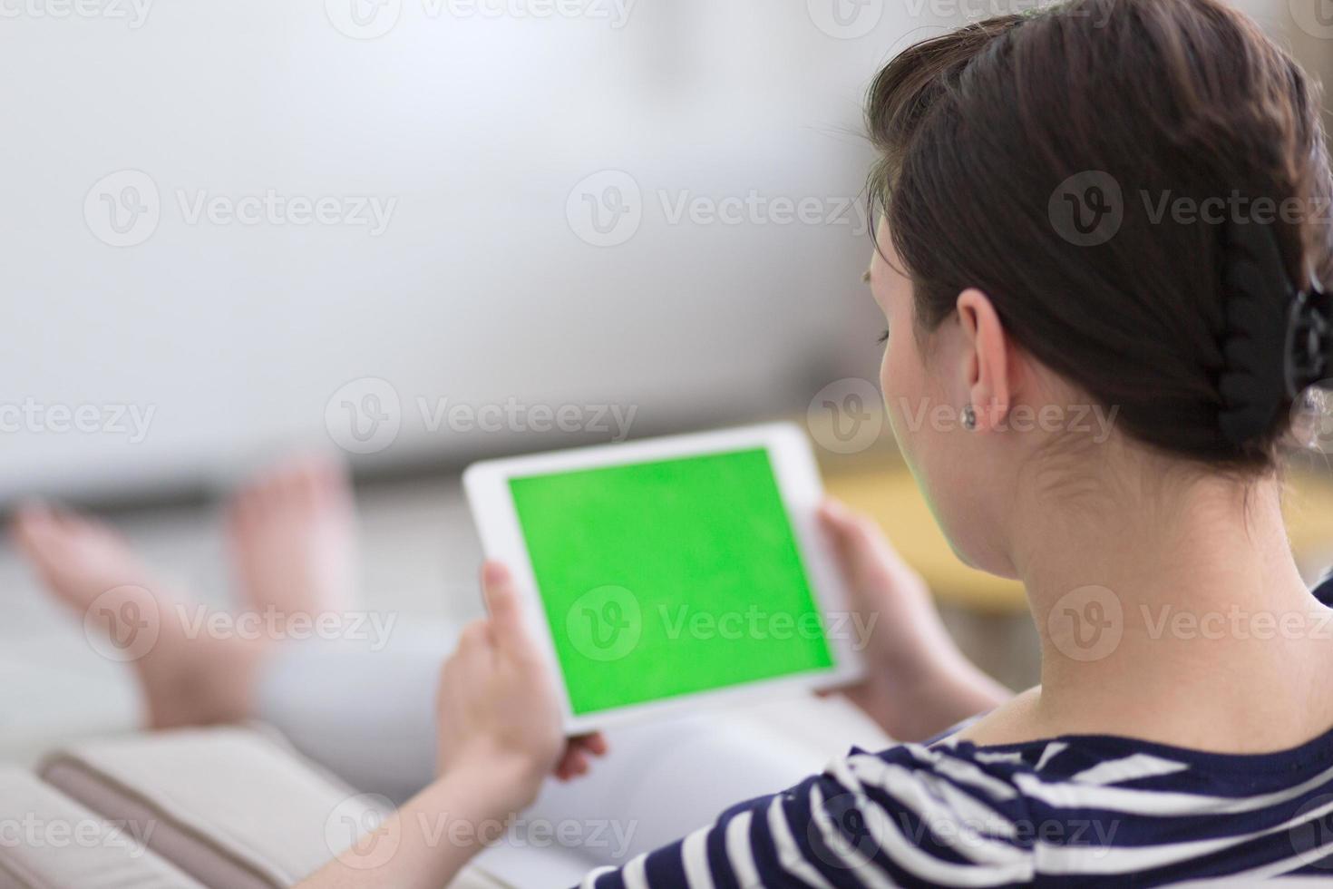 femme sur un canapé à l'aide d'une tablette photo