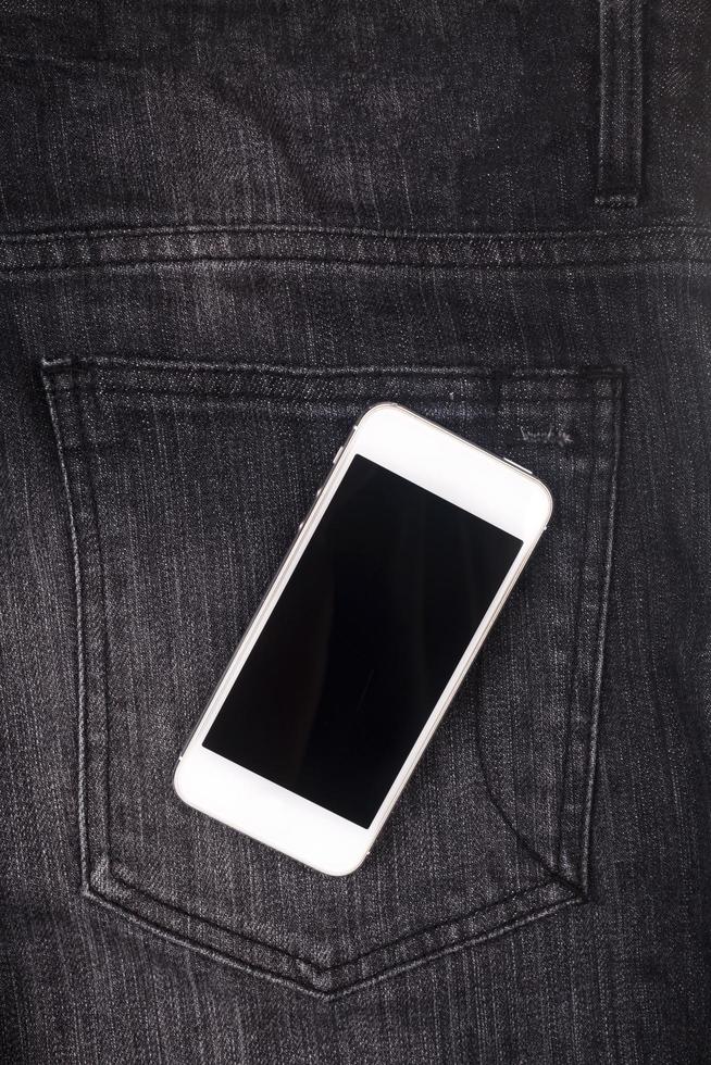 téléphone portable blanc sur poche avec écran noir photo