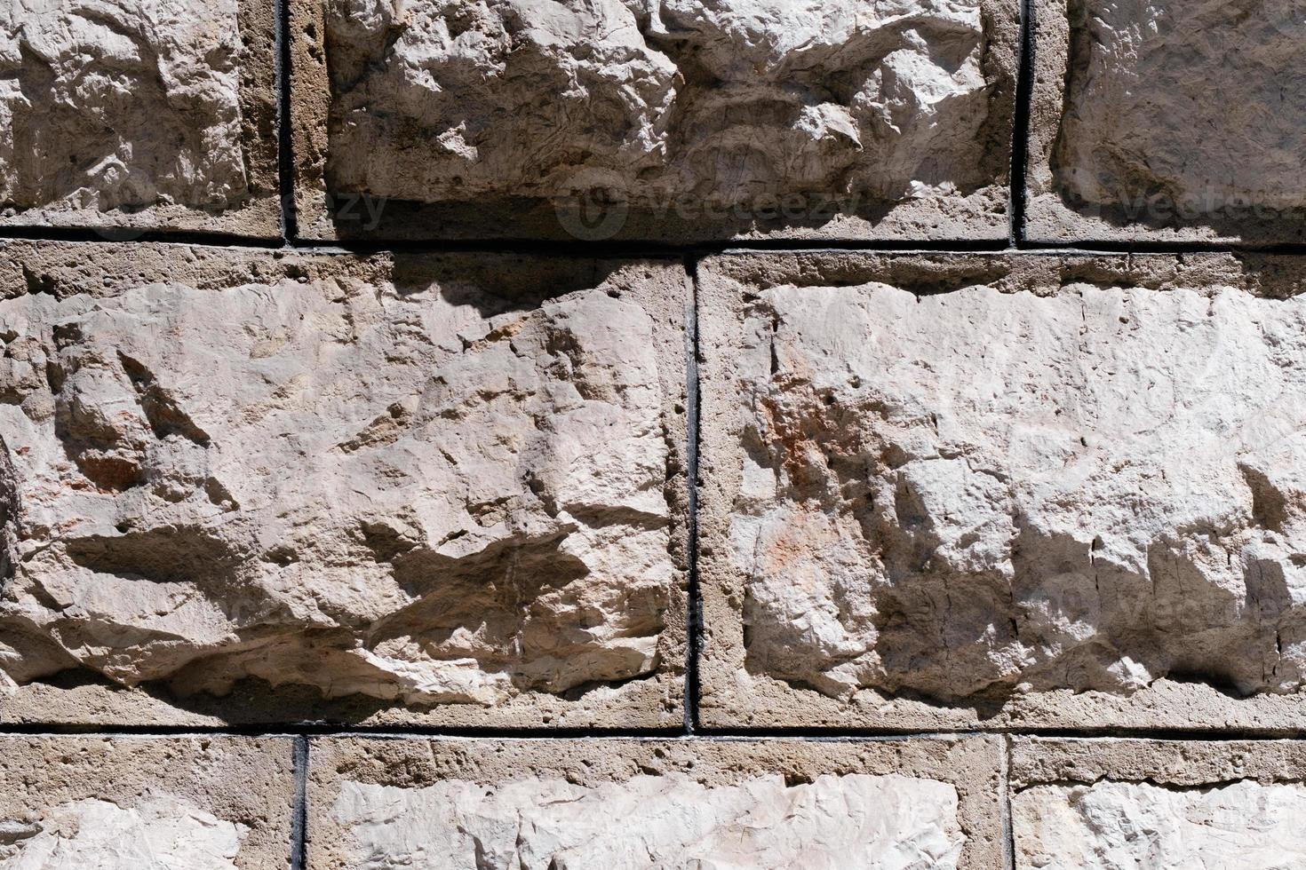 ancienne texture de mur de pierre, surface de mur de brique rétro altérée, surface de maçonnerie texturée, fond grunge rugueux. photo