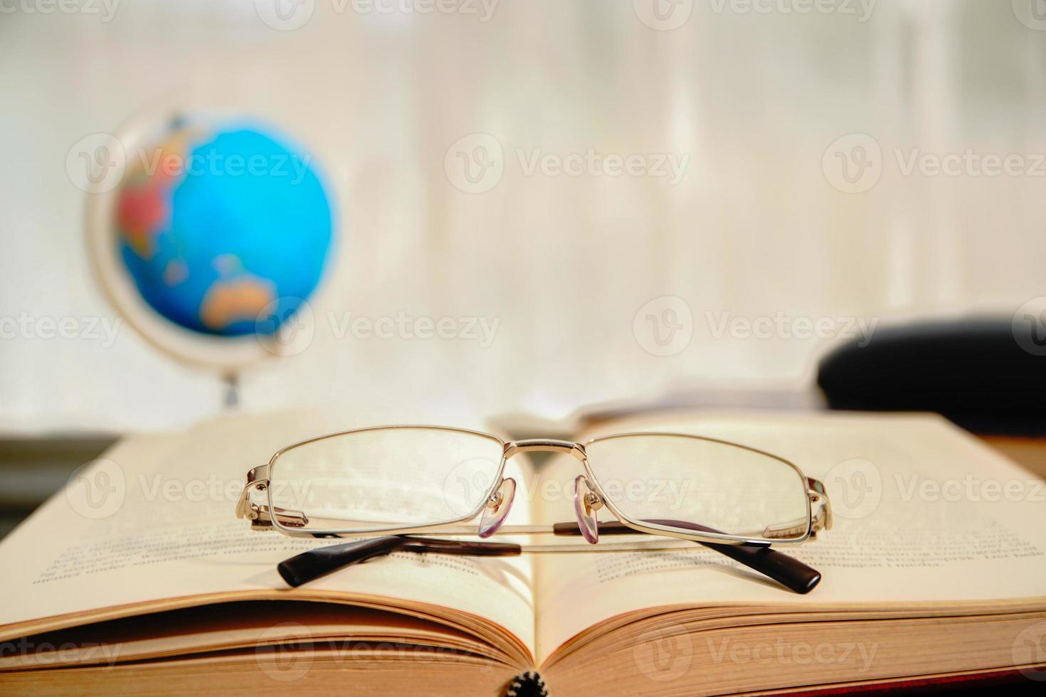 lunettes de lecture posées sur un livre ouvert photo