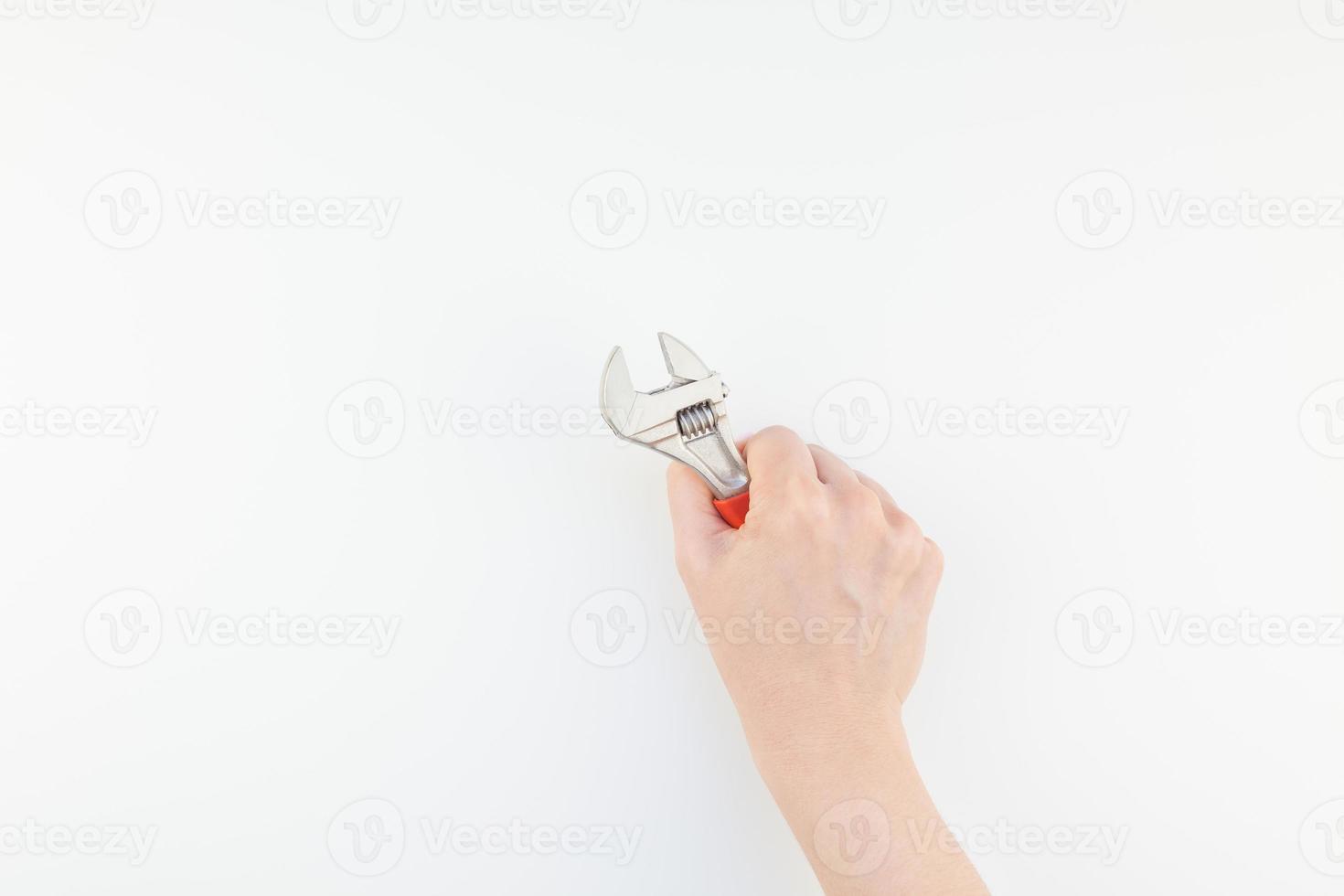 main de femme tenant une clé sur fond blanc photo