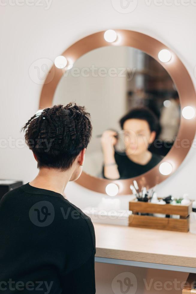 jolie femme au miroir dans un studio de beauté photo