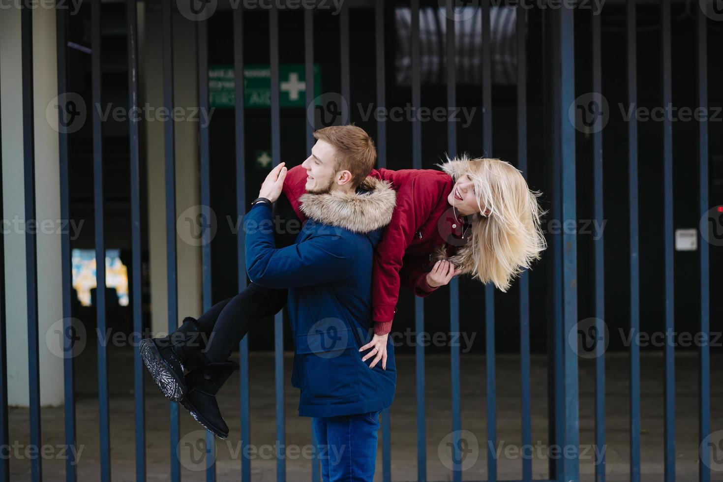 le gars sur l'épaule porte la fille, l'hiver à l'extérieur. photo