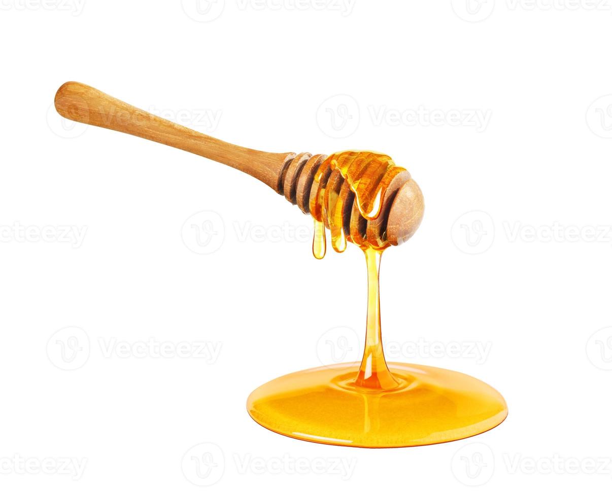dégoulinant de miel isolé sur fond blanc, miel dégoulinant, louche de miel photo