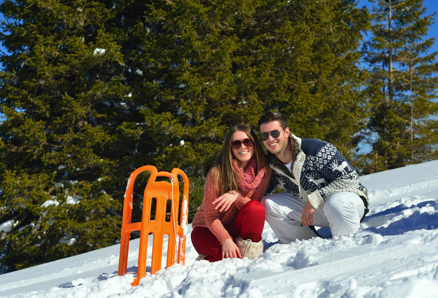 famille s'amusant sur la neige fraîche pendant les vacances d'hiver photo