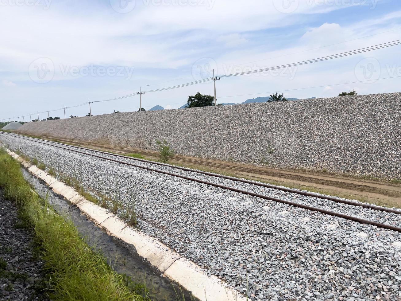 le grand tas de pierres le long de la voie ferrée pour la construction d'un chemin de fer à double voie. photo