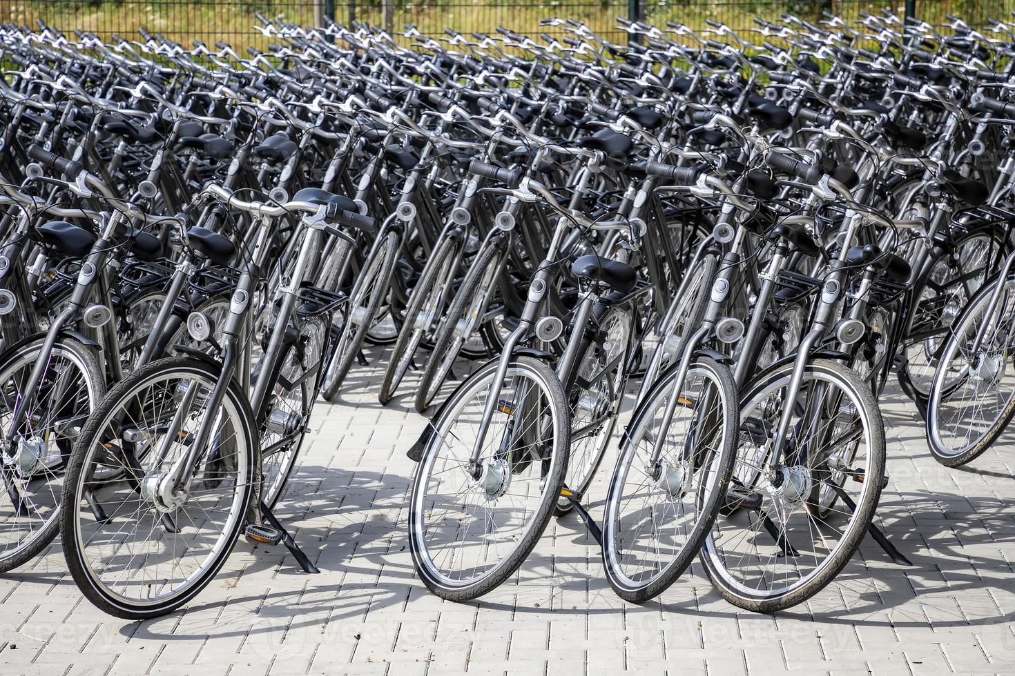 station de stationnement pour vélos pleine de vélos. nombreux vélos garés. photo