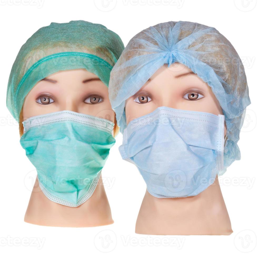 têtes de médecin factices portant une casquette et un masque chirurgicaux en textile photo