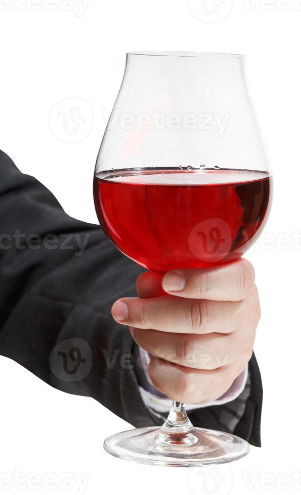 vue de face du verre de vin rouge dans la main de l'homme d'affaires photo