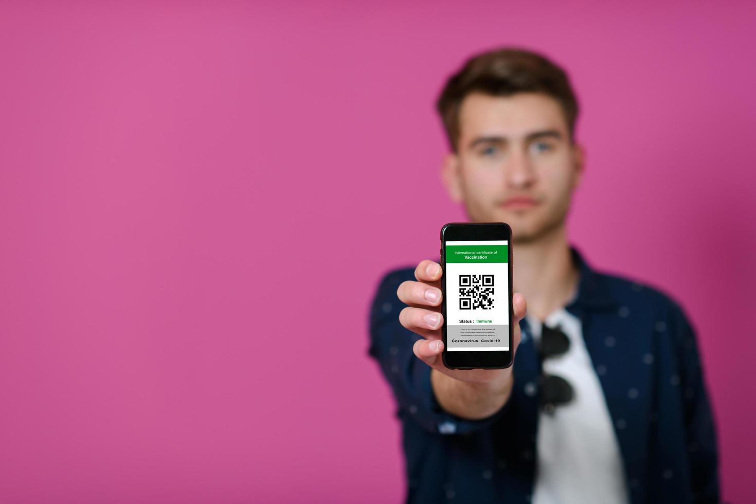 passeport covid, un jeune homme montre son code et son passeport covid sur son téléphone portable photo