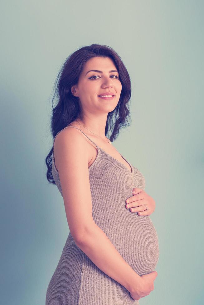 portrait de femme enceinte sur fond bleu photo