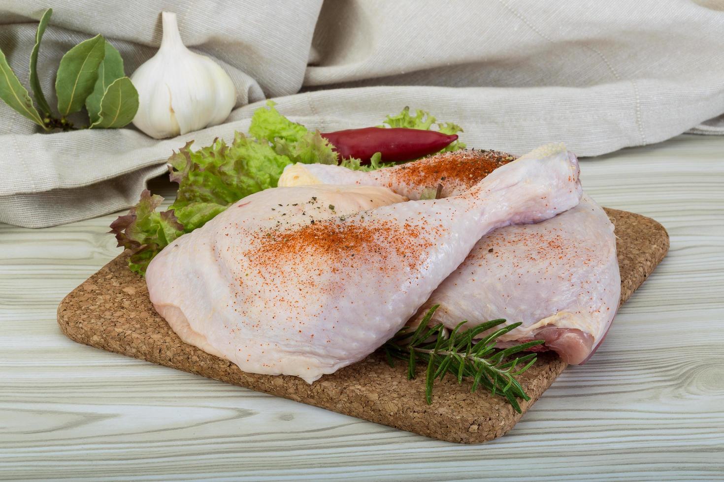 cuisse de poulet sur planche de bois et fond en bois photo