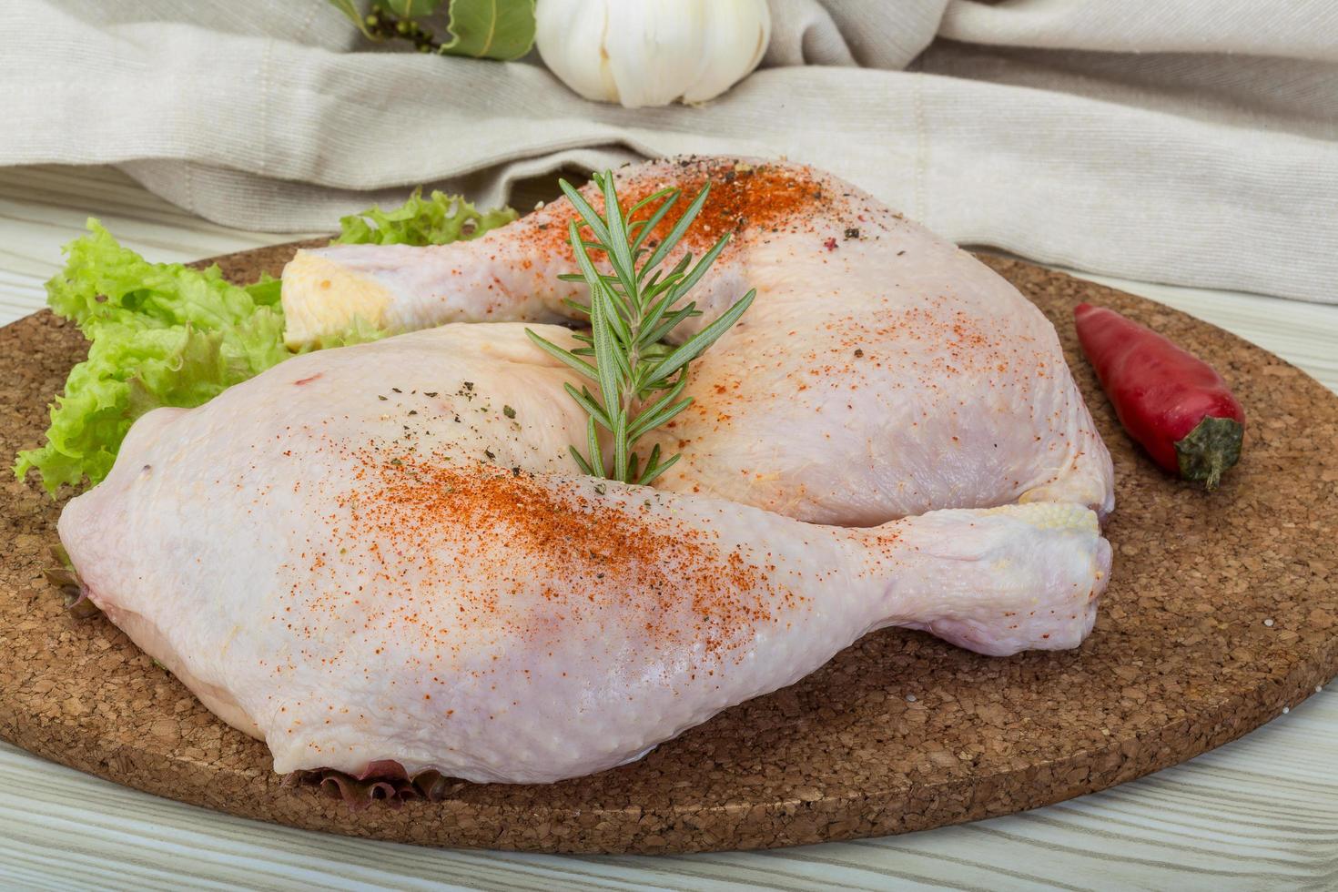 cuisse de poulet sur planche de bois et fond en bois photo