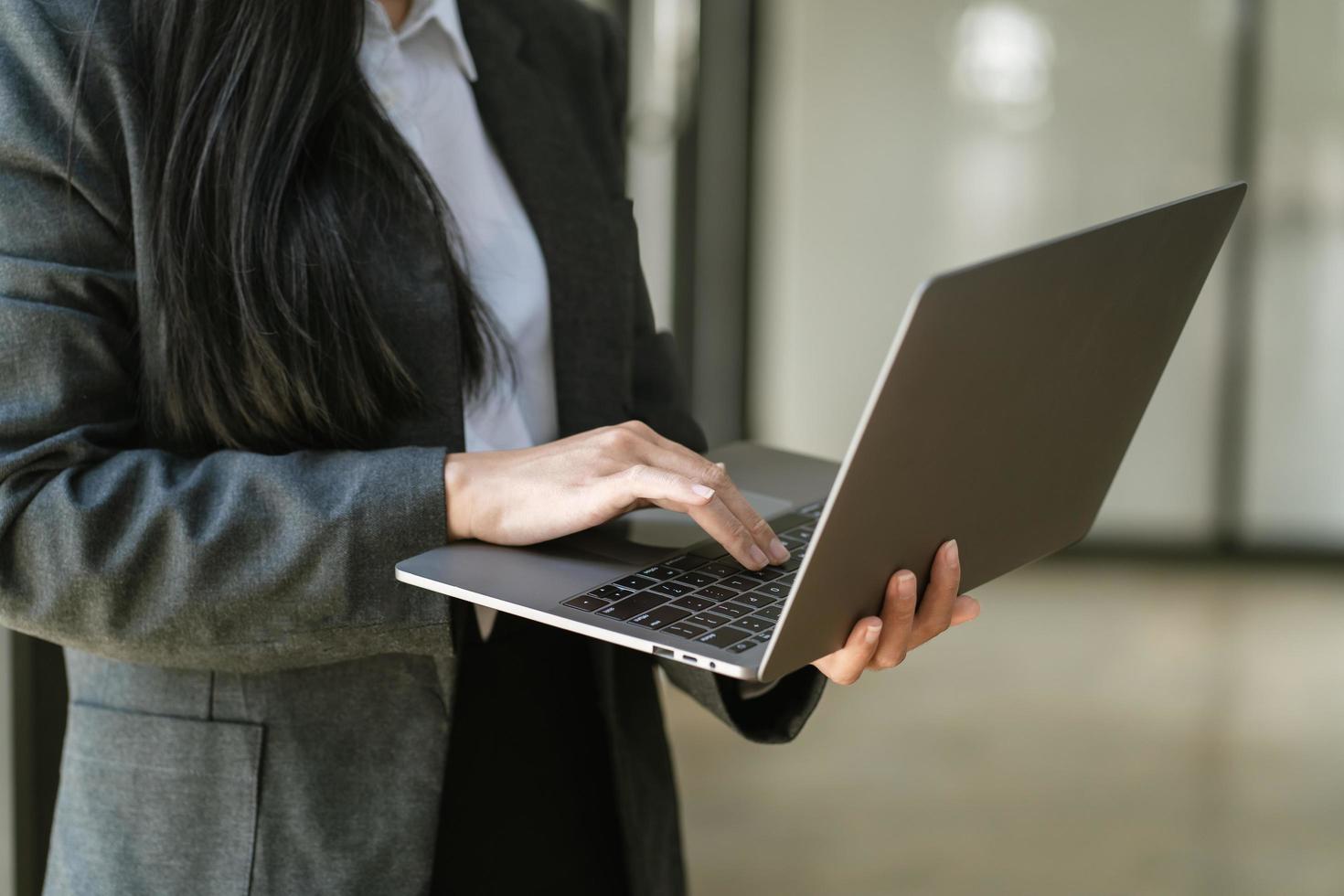 femme d'affaires tenant un ordinateur portable au bureau photo