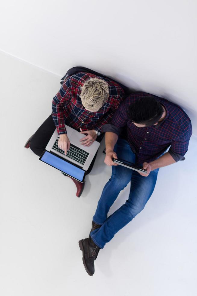 vue de dessus d'un couple travaillant sur un ordinateur portable au bureau de démarrage photo