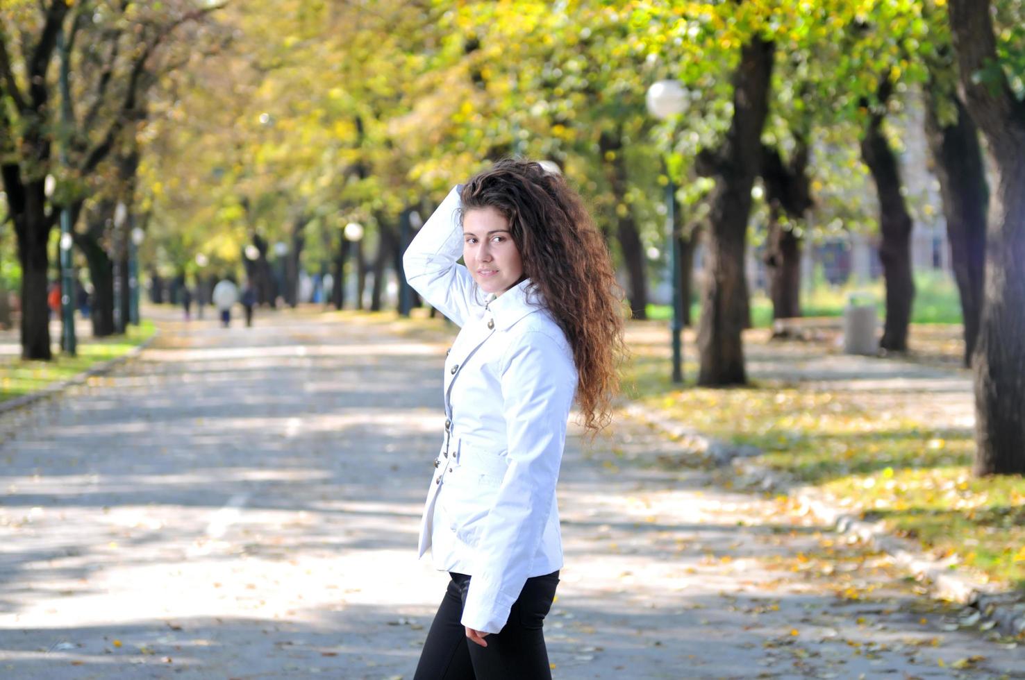 brune jolie jeune femme souriante à l'extérieur dans la nature photo