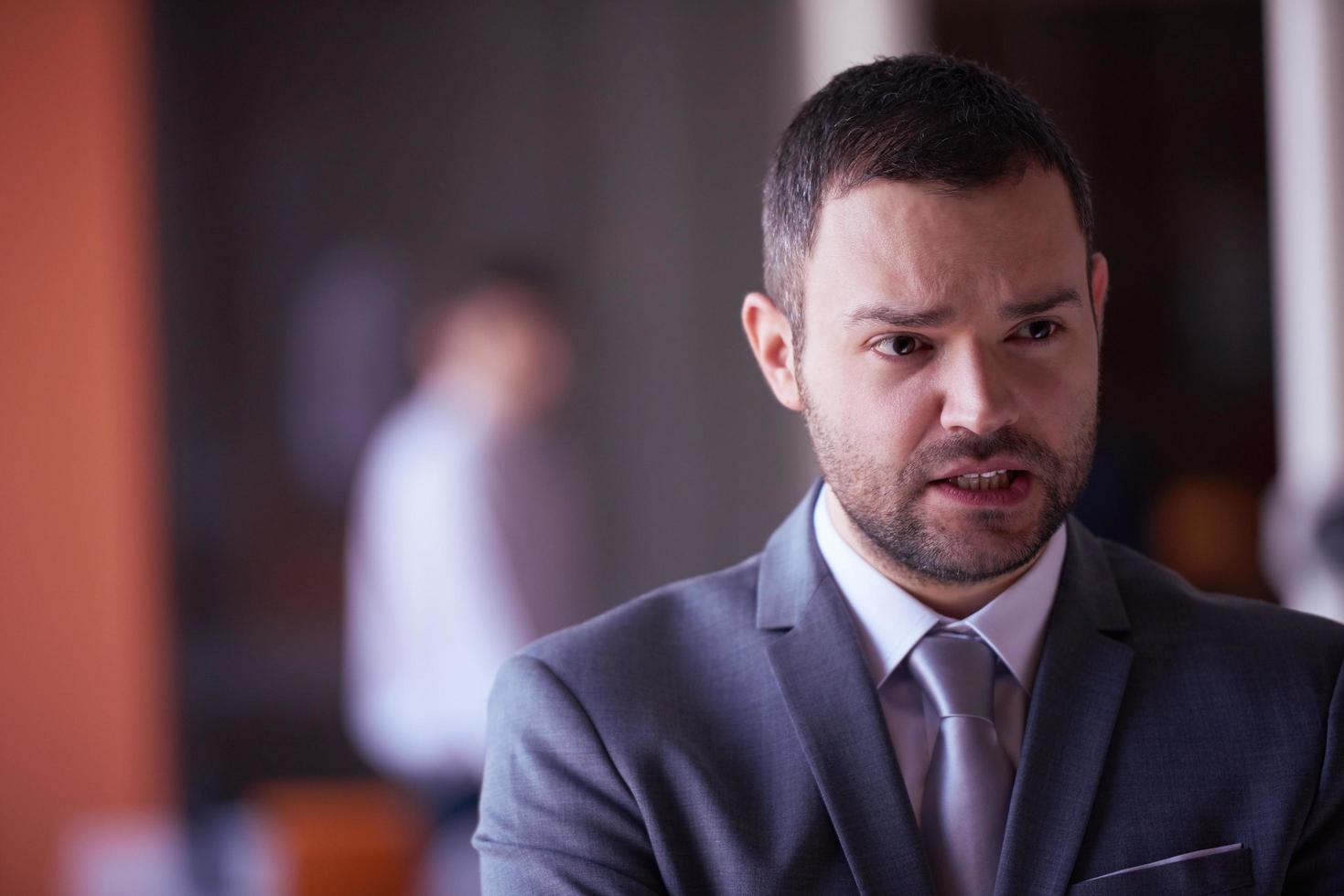 portrait de jeune homme d'affaires au bureau moderne photo