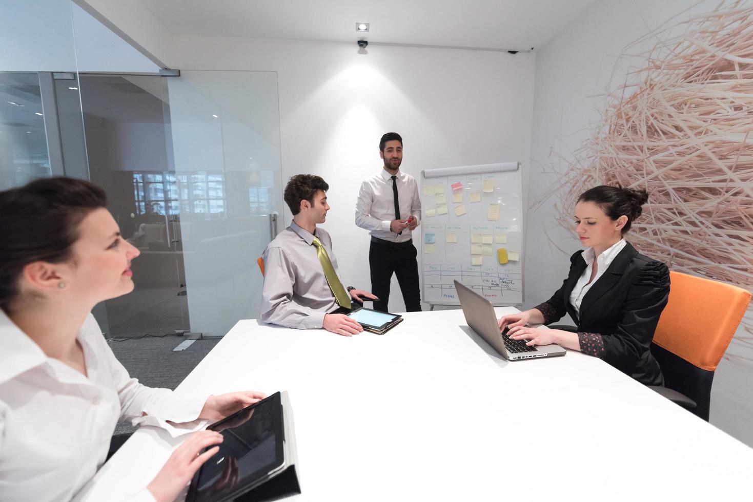 groupe de gens d'affaires remue-méninges et prise de notes sur le tableau à feuilles mobiles photo