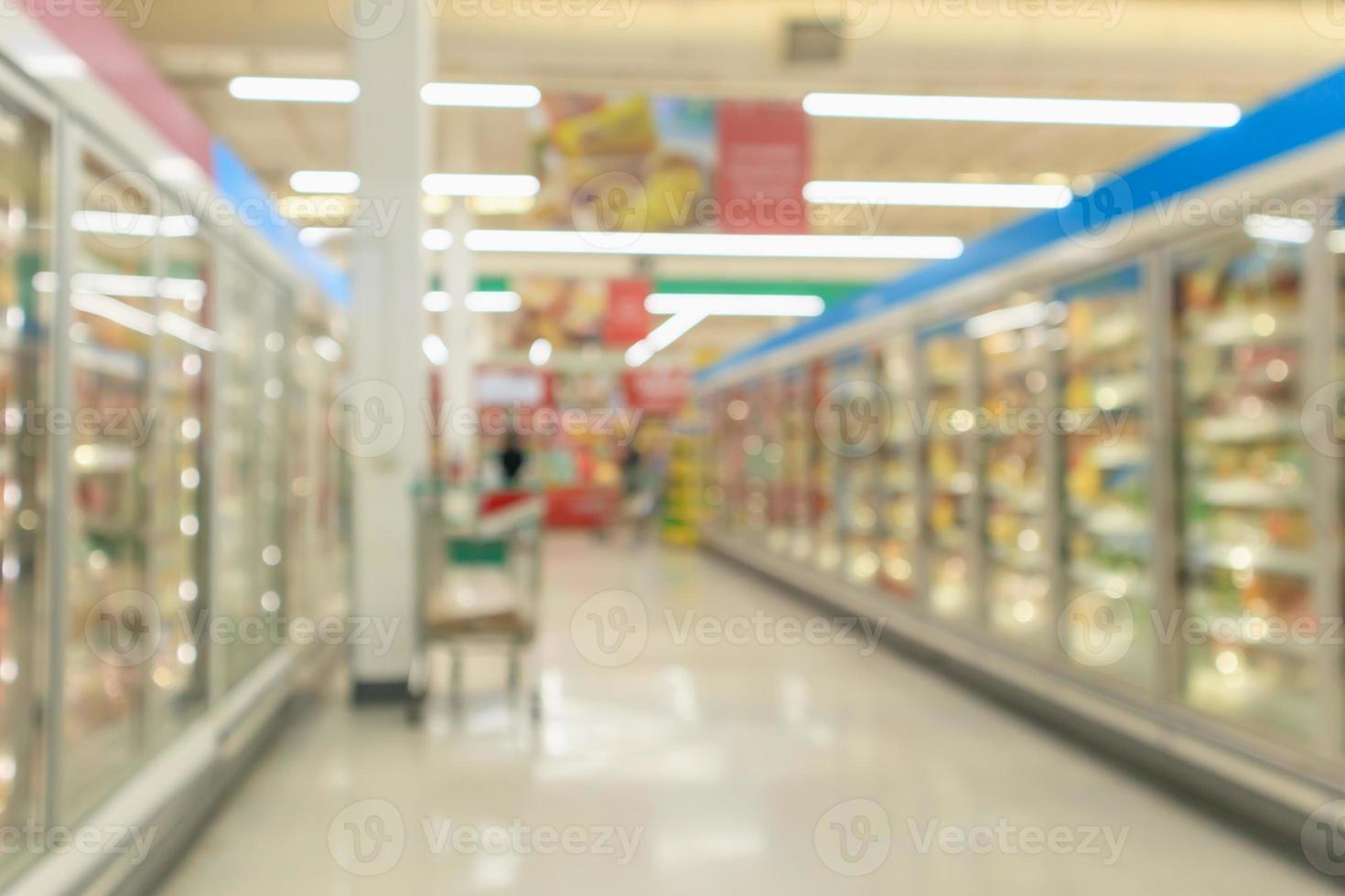 allée de supermarché avec réfrigérateurs commerciaux congélateur montrant des aliments surgelés arrière-plan flou abstrait photo