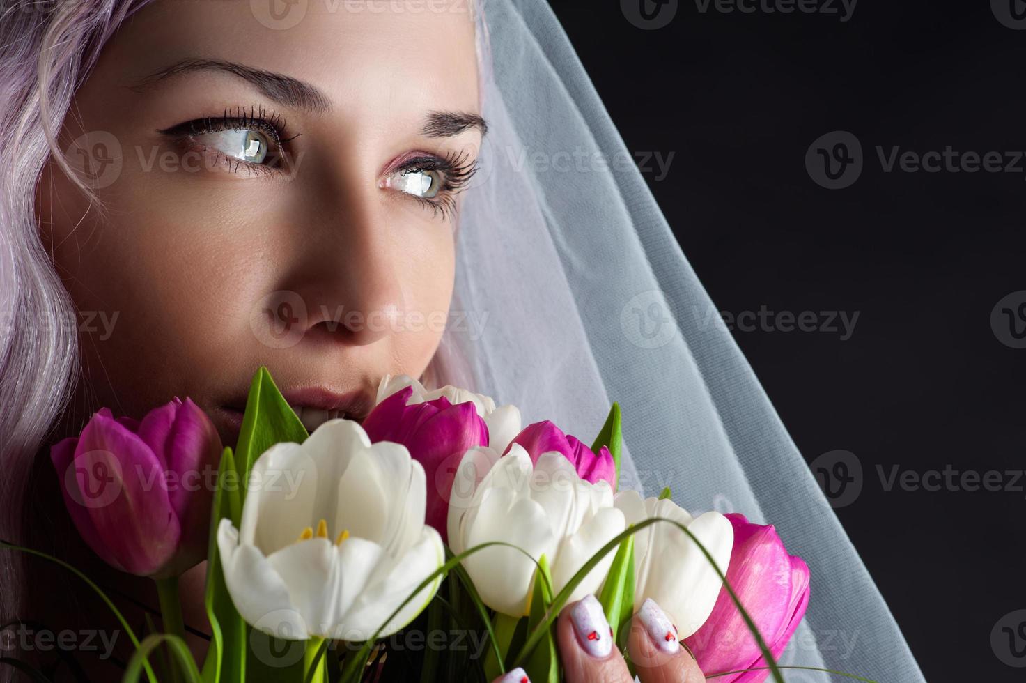 visage de femme avec un bouquet de tulipes photo