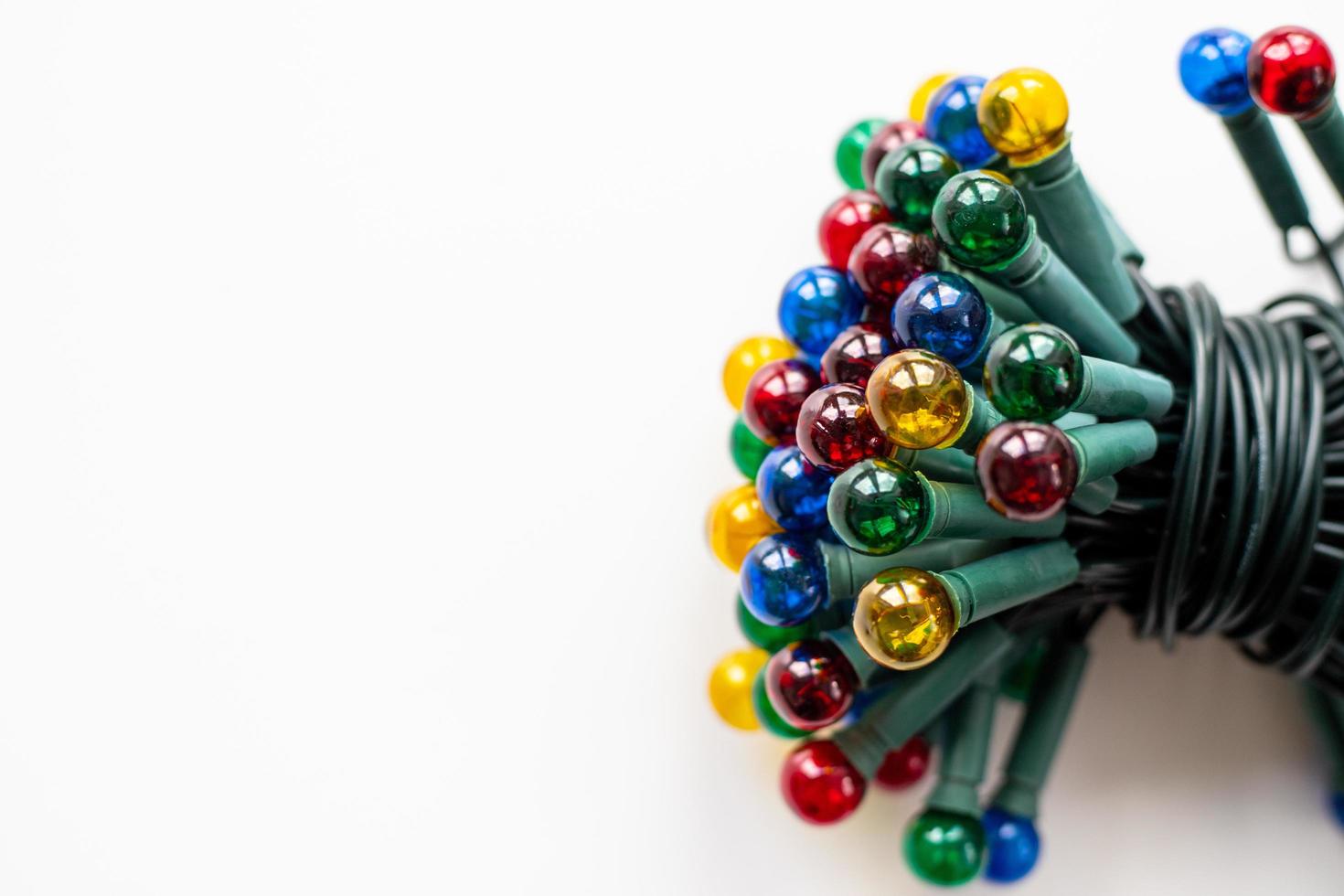 Diverses lumières de Noël colorées pour un arbre de Noël sur fond blanc photo