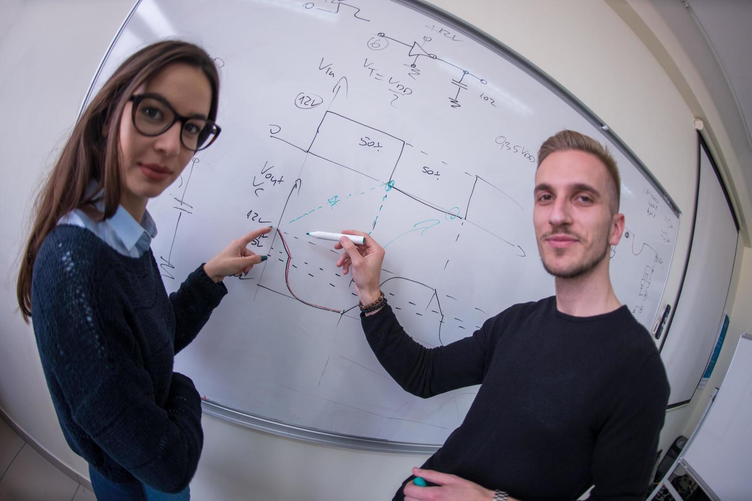 étudiants écrivant sur le tableau blanc photo