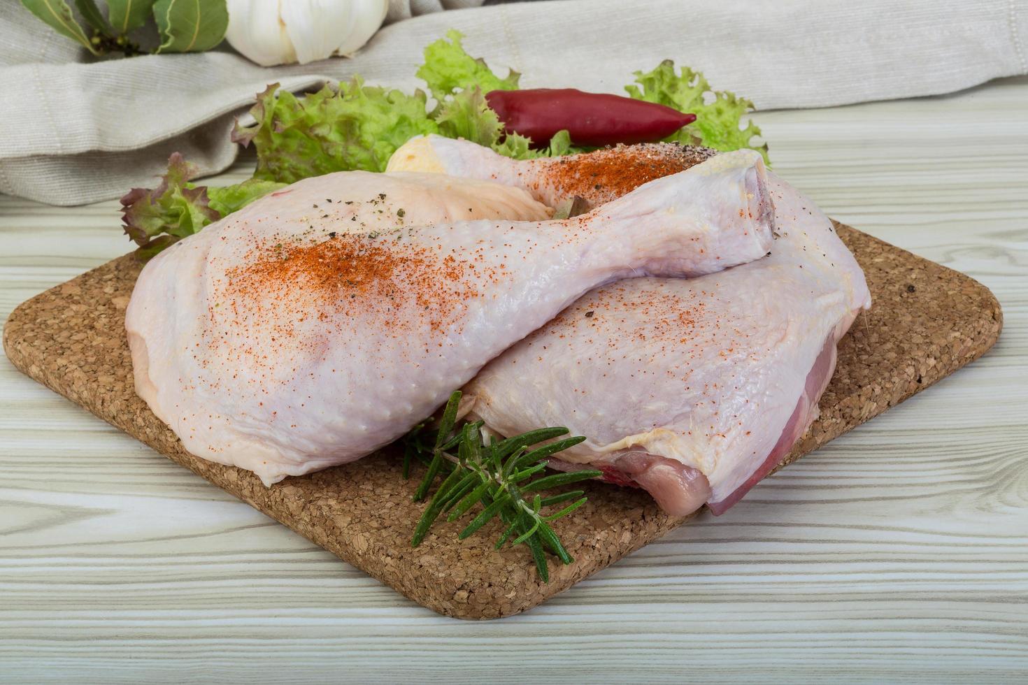 cuisse de poulet sur planche de bois et fond en bois photo