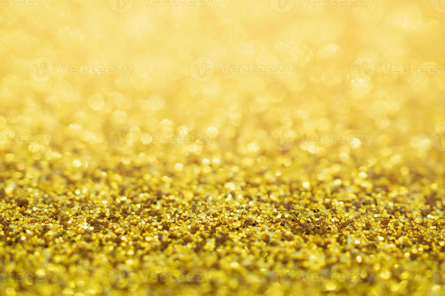 paillettes d'or abstraites texture de fond de noël festif flou avec lumière bokeh photo