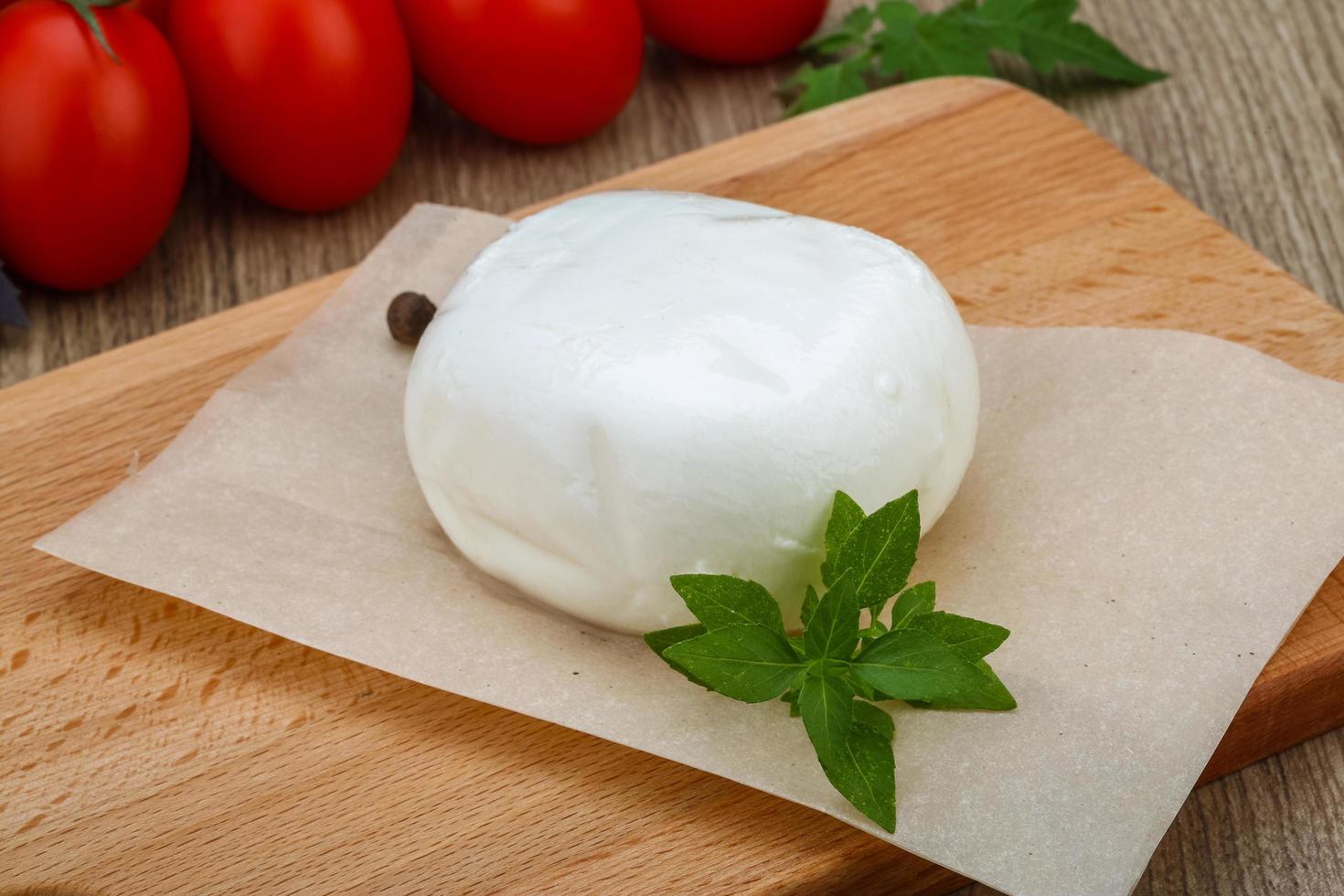 mozzarella sur planche de bois et fond en bois photo