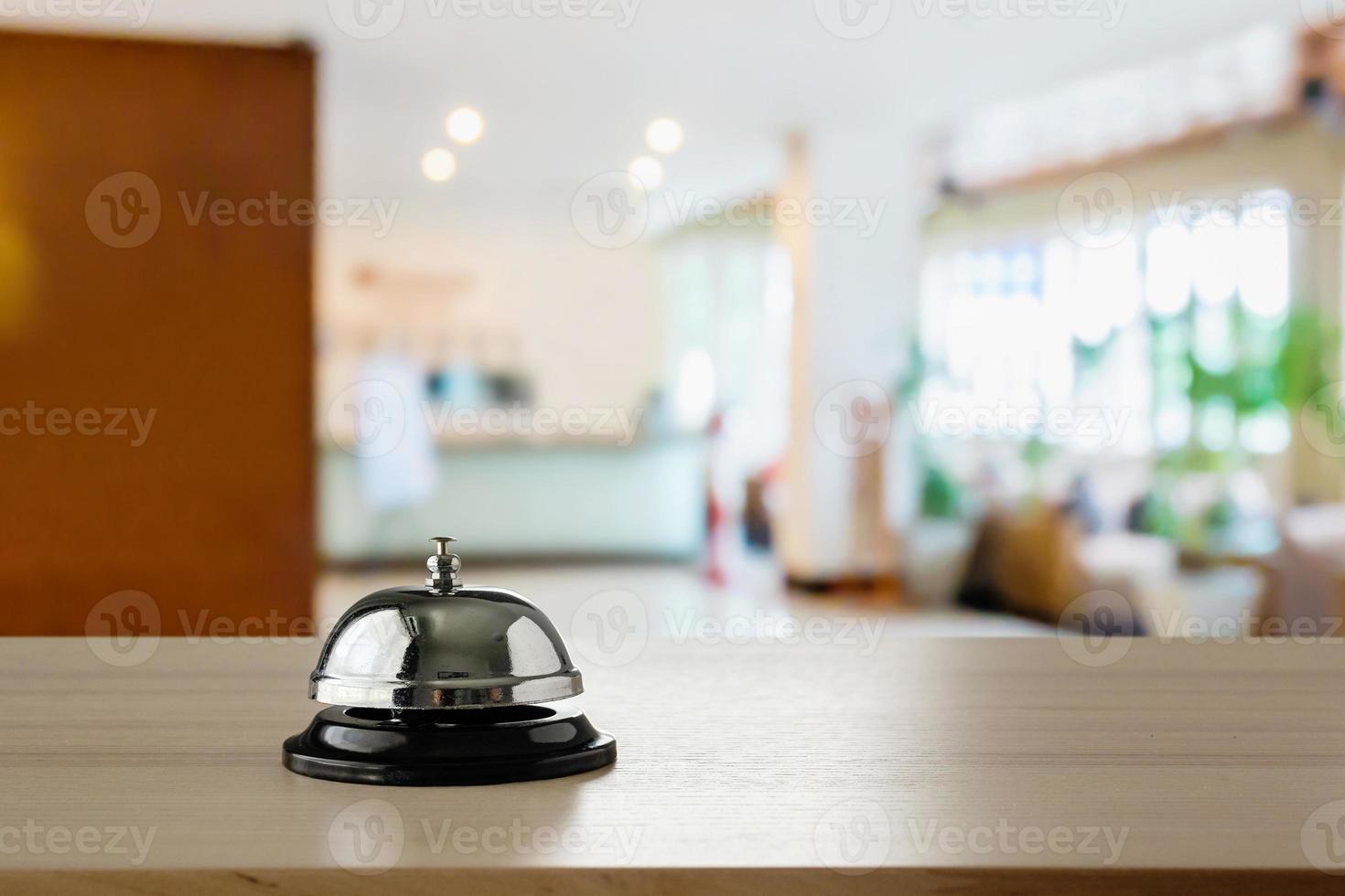 cloche de service hôtelier sur fond de comptoir en bois photo