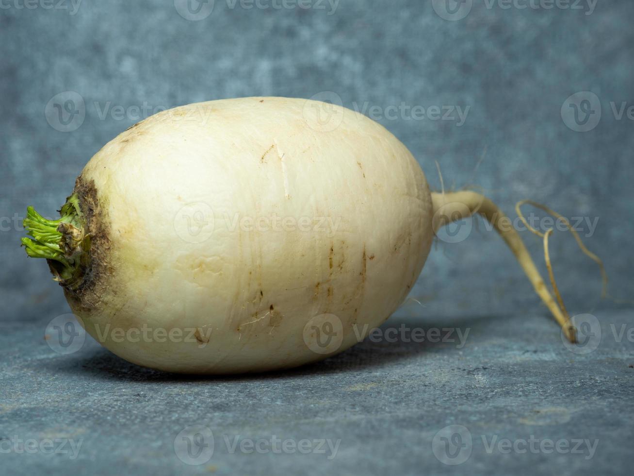 daikon sur fond noir. radis japonais. récolte, un légume-racine photo