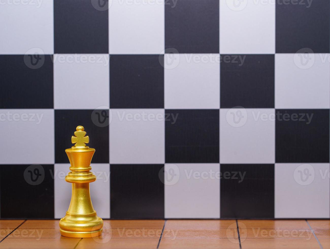 pièce d'échecs du roi d'or sur l'échiquier en bois 0 photo