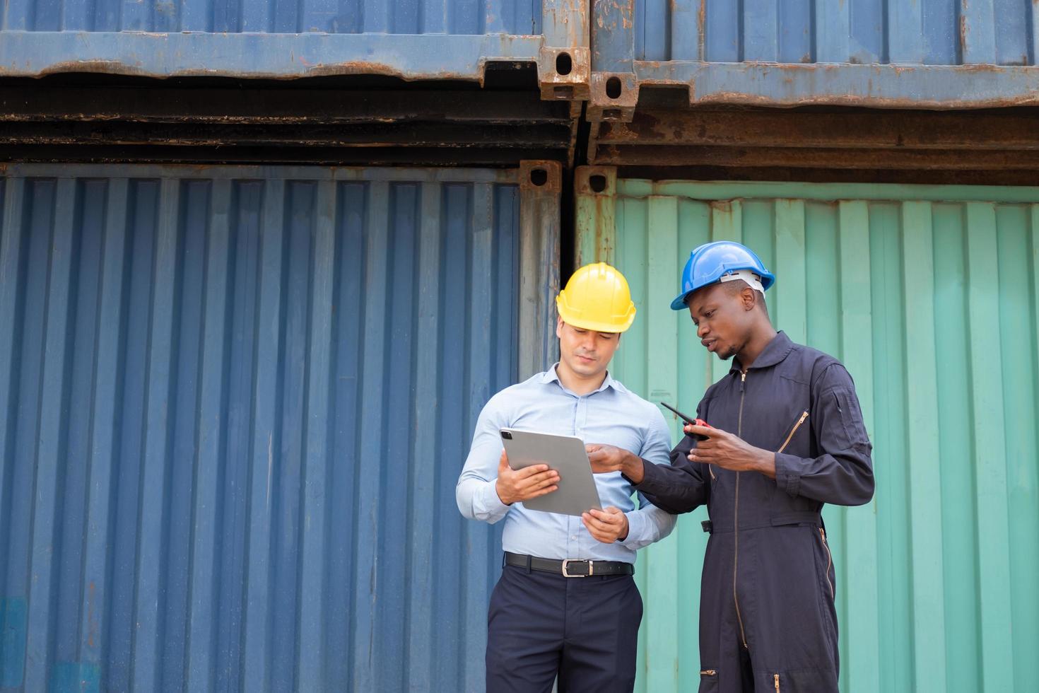 mise au point sélective sur un travailleur noir africain tout en discutant avec son superviseur et en inspectant l'état de toutes les expéditions de conteneurs, les personnes et les travailleurs dans la livraison, l'importation et l'exportation de fret. photo