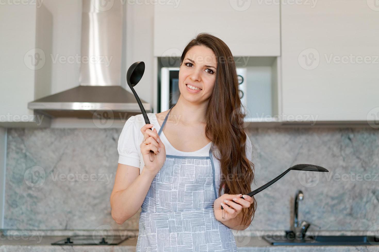 jeune femme au foyer caucasienne souriante et attrayante dans des vêtements légers décontractés photo