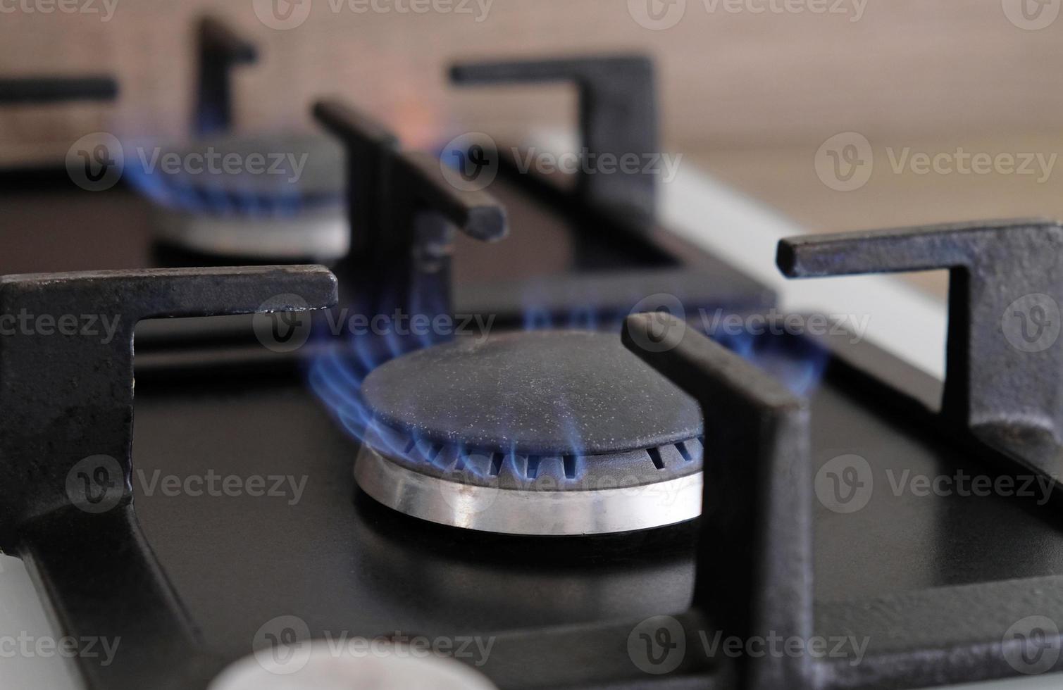 gros plan des flammes bleues du feu sur un brûleur à gaz dans la cuisine pour la cuisson. flamme de gaz dans une chaudière à gaz photo