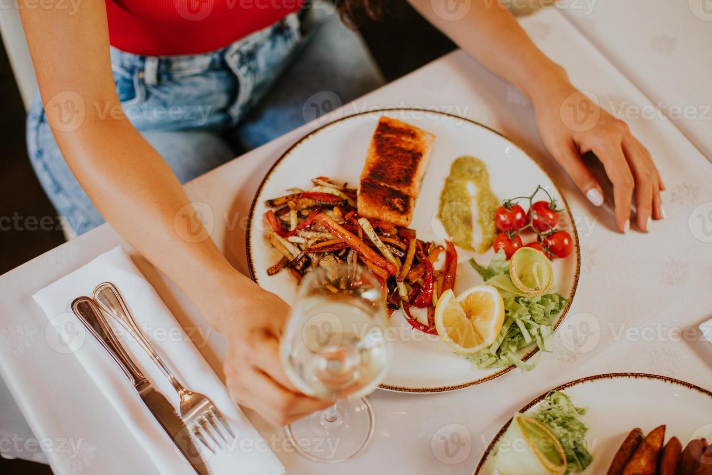 jeune couple en train de déjeuner avec du vin blanc au restaurant photo