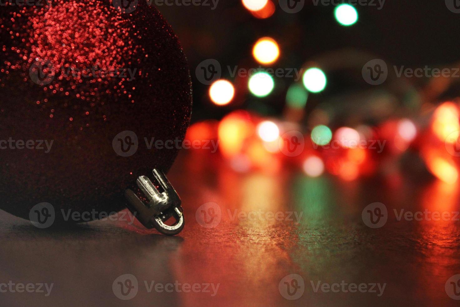 gros plan de boule de noël sur fond de lumières multicolores de la ville. concept de noël, nouvel an. arrière-plan flou. photo