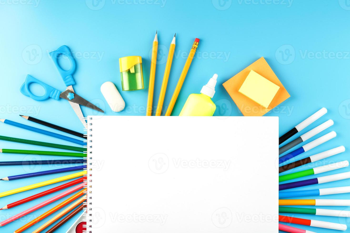 un ensemble de fournitures scolaires pour l'apprentissage et le développement créatif sur fond bleu. photo