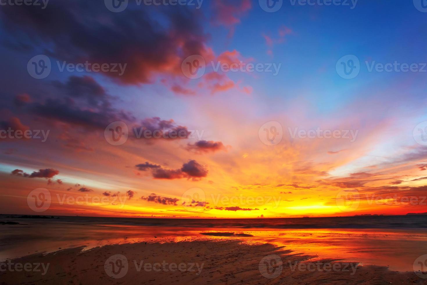 un coucher de soleil orange chaud dans un ciel bleu qui s'assombrit photo