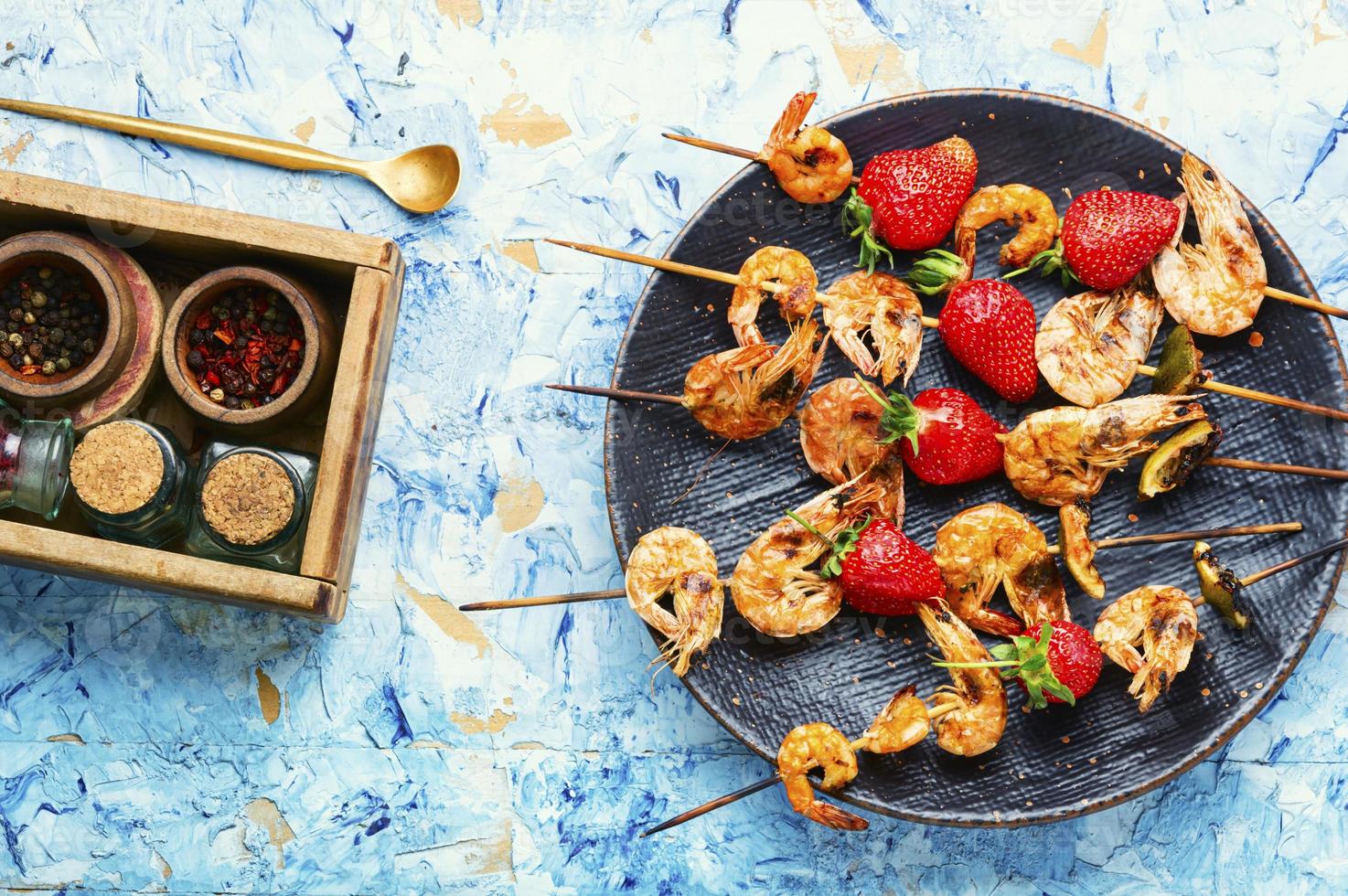 délicieuses crevettes rôties sur une brochette avec des fraises photo