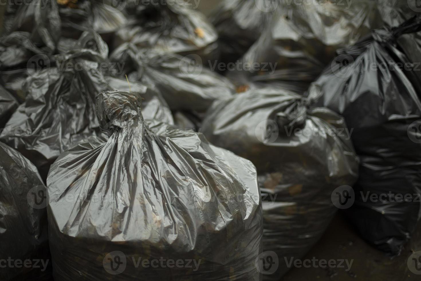 sacs poubelles noirs. nettoyage dans la rue. sacs à déchets. plastique noir. photo