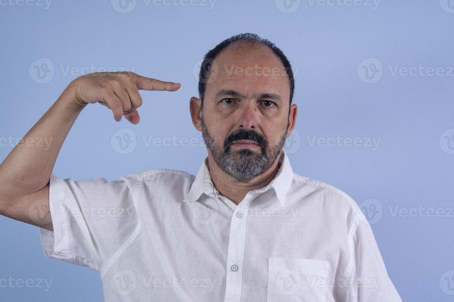 portrait d'homme barbu de 60 ans sur fond bleu photo