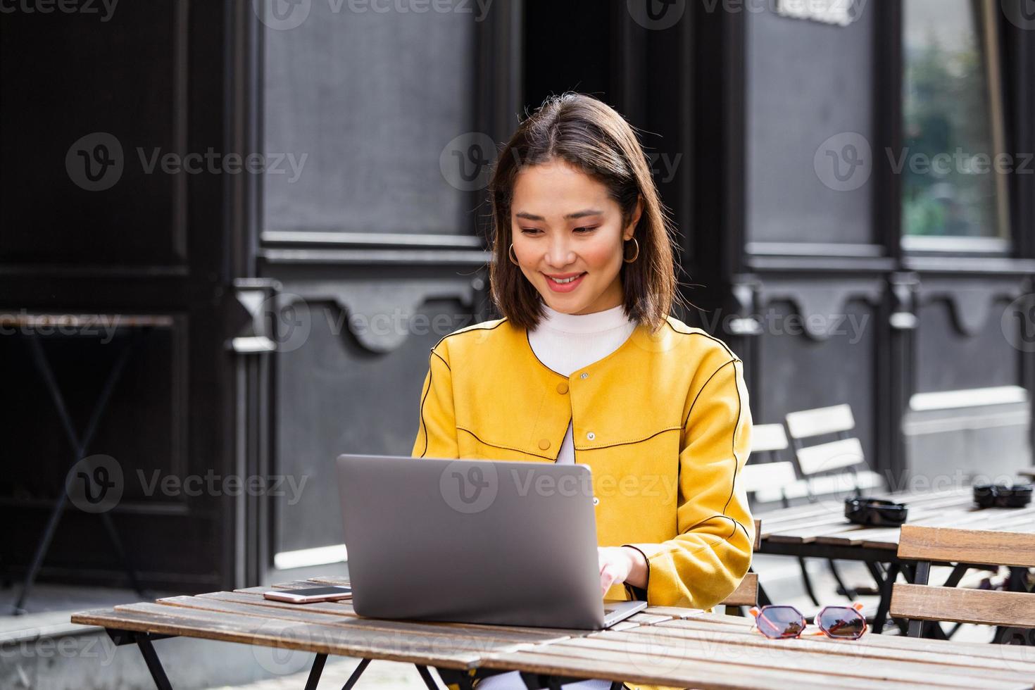 une jeune femme d'affaires asiatique travaille dans une cafétéria pendant sa pause. femme faisant une pause. appréciant le travail du café. faire des affaires depuis un café photo