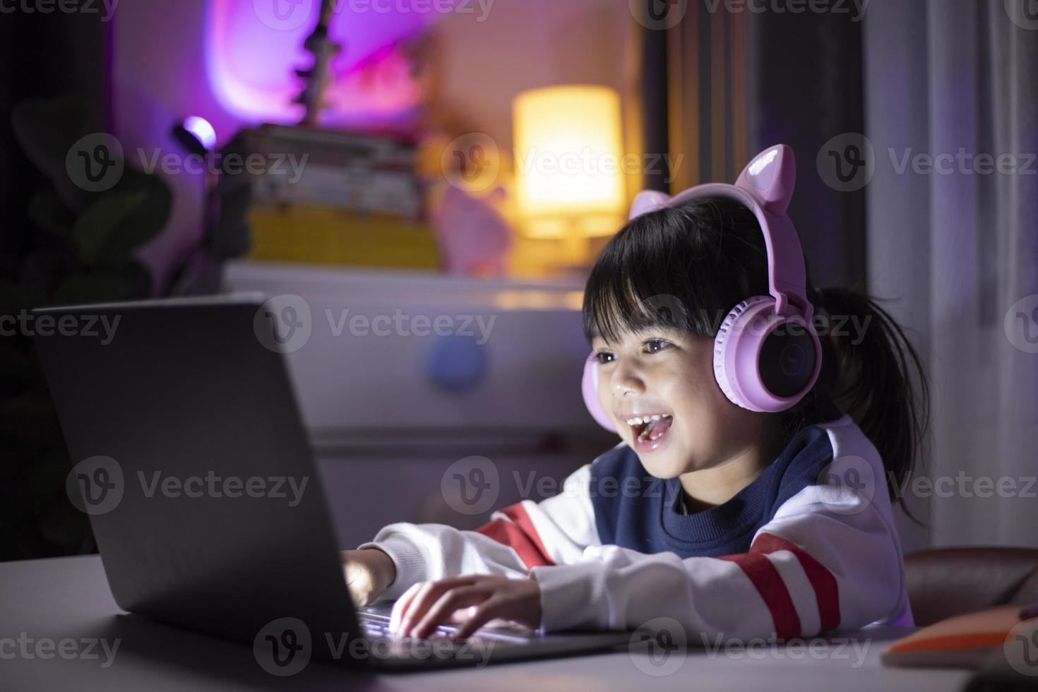banderole de fille asiatique jouant à un jeu vidéo avec une expression gagnante dans la salle de jeux. photo