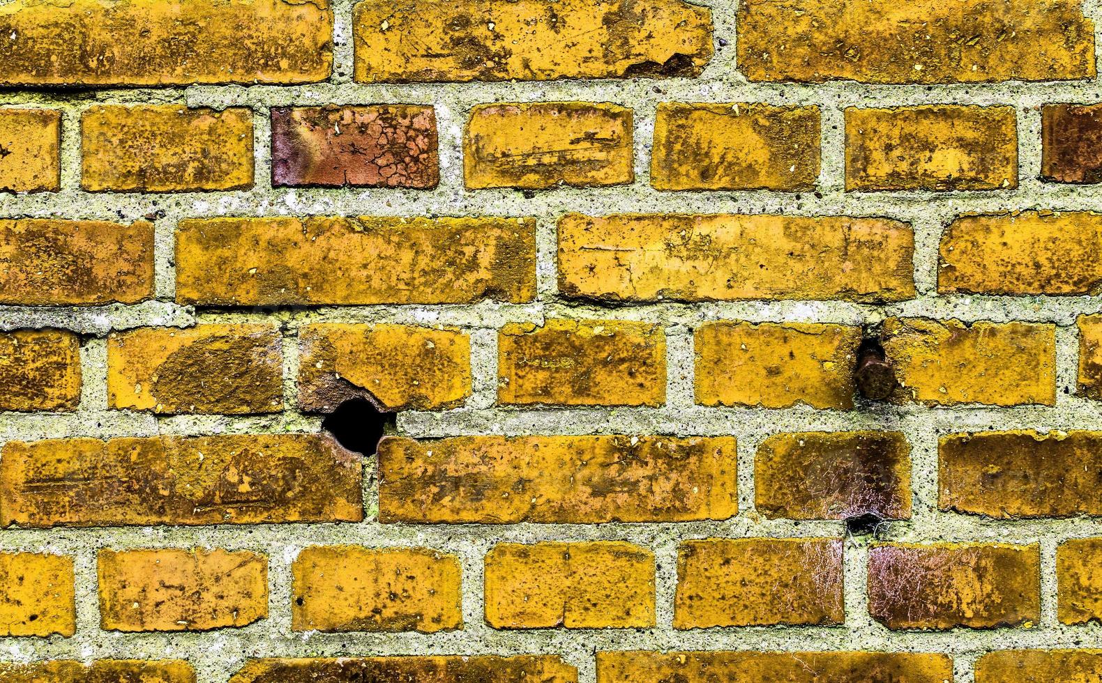 vue détaillée sur une texture colorée de mur de briques anciennes et altérées comme arrière-plan panoramique. photo