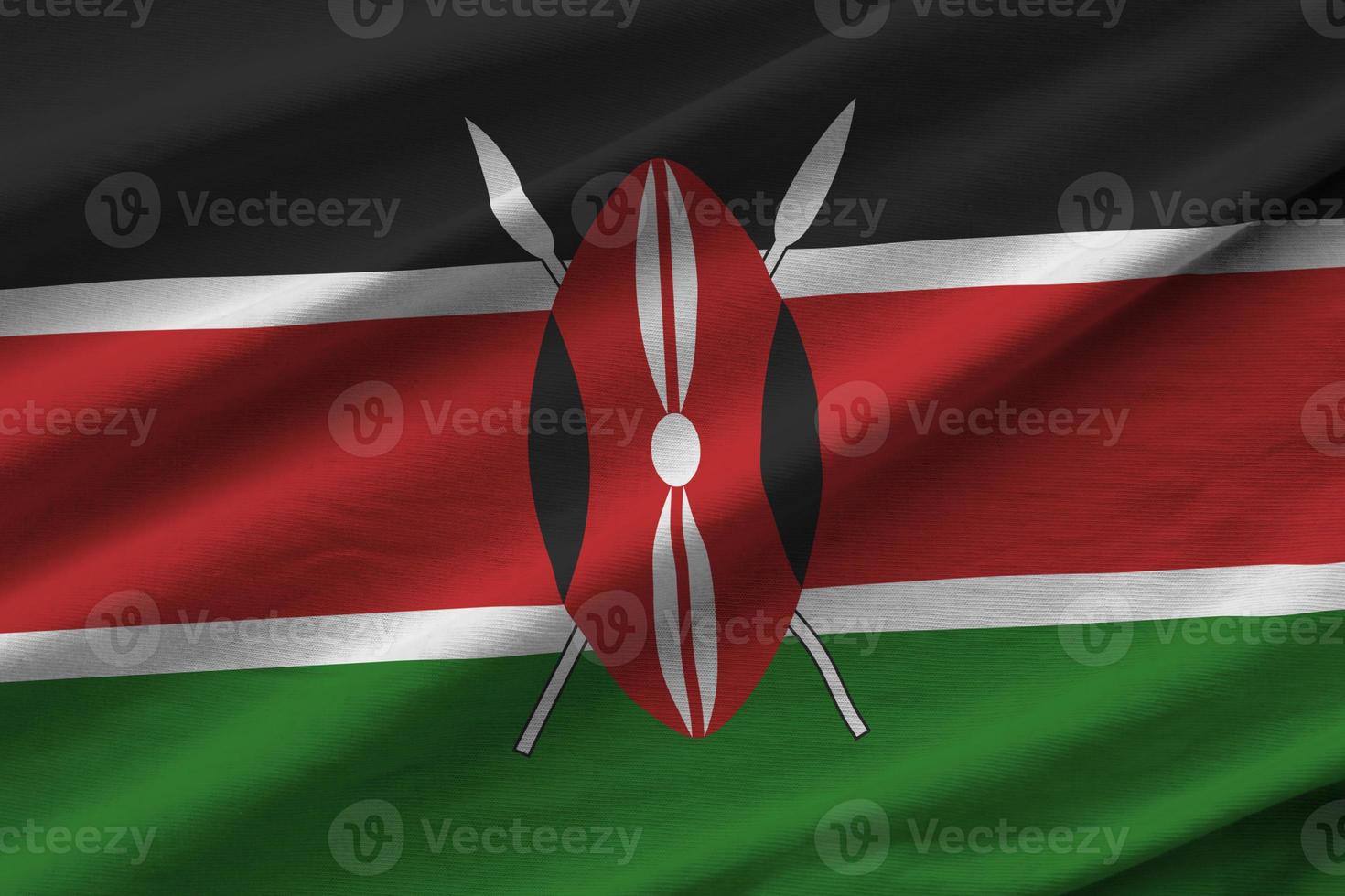 drapeau du kenya avec de grands plis agitant de près sous la lumière du studio à l'intérieur. les symboles et couleurs officiels de la bannière photo